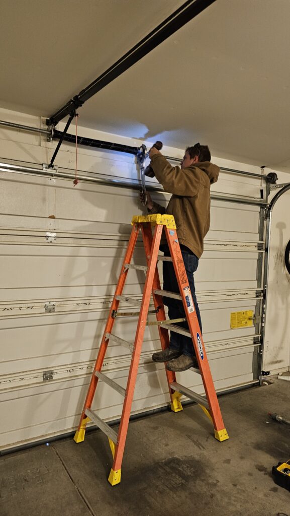 garage door repair in Tucson Eddie winding a torsion spring on a Tucson garage door